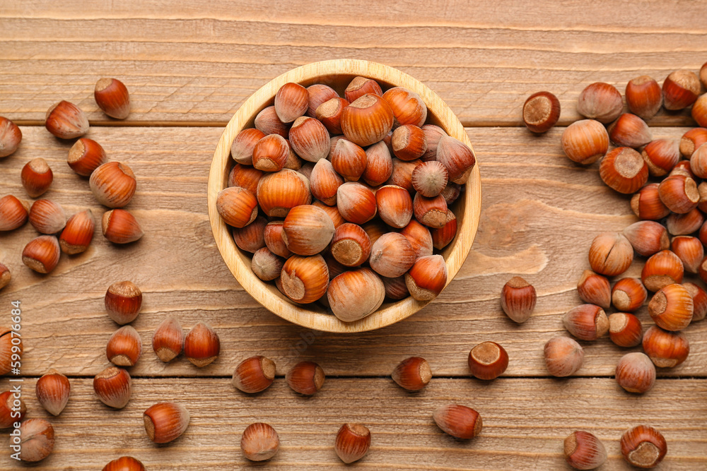 Bowl with shelled hazelnuts on wooden background Bowl with shelled hazelnuts on wooden background