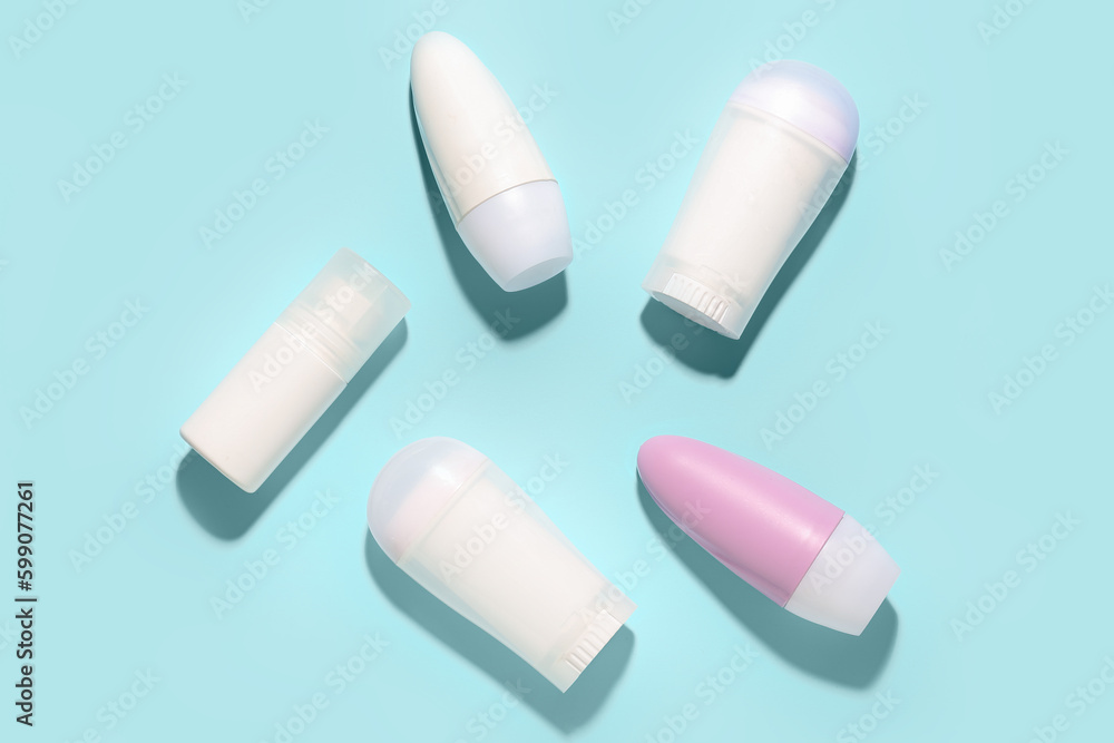 Different deodorant bottles on blue background Different deodorant bottles on blue background