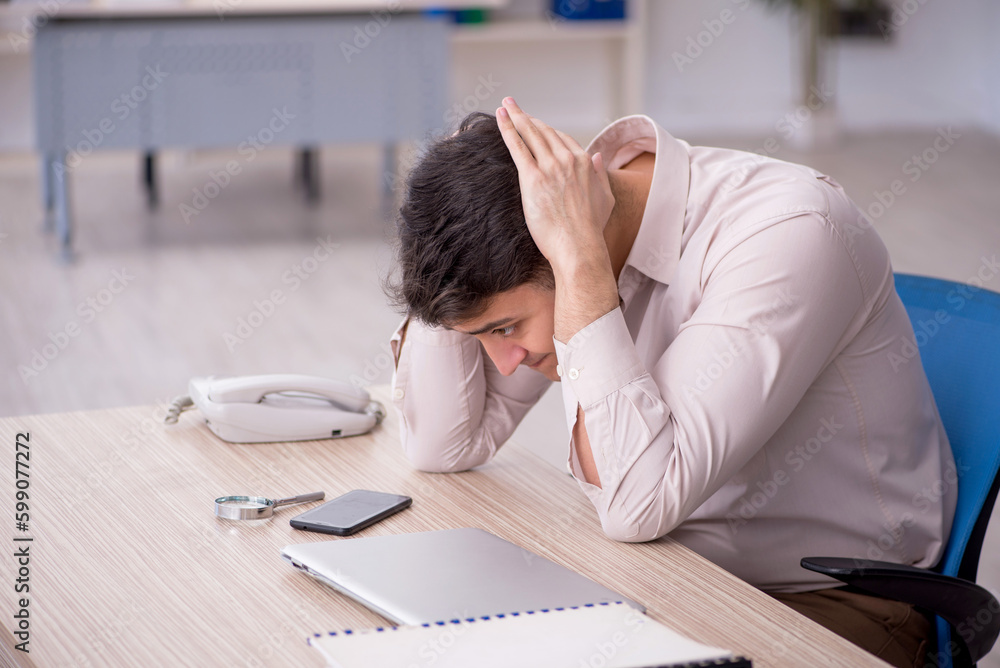 Young male employee working in the office Young male employee working in the office
