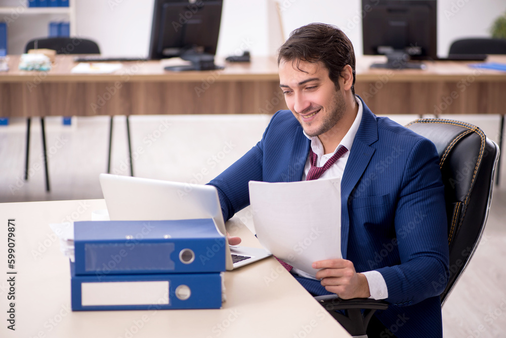 Young male employee working in the office Young male employee working in the office