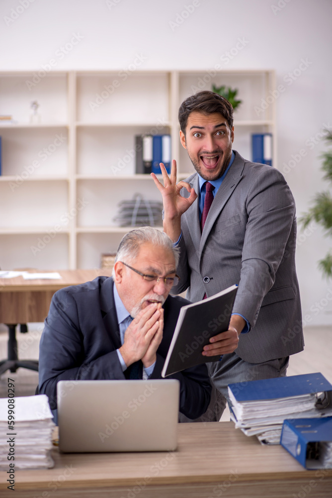 Two male colleagues working in the office Two male colleagues working in the office