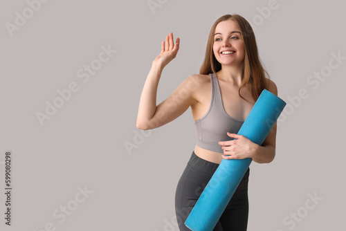 Smiling young woman holding...