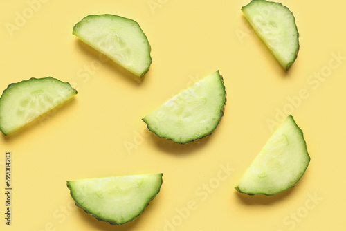 Slices of cucumber on yellow background