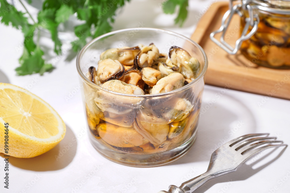 Glass bowl of pickled mussels on white background Glass bowl of pickled mussels on white background