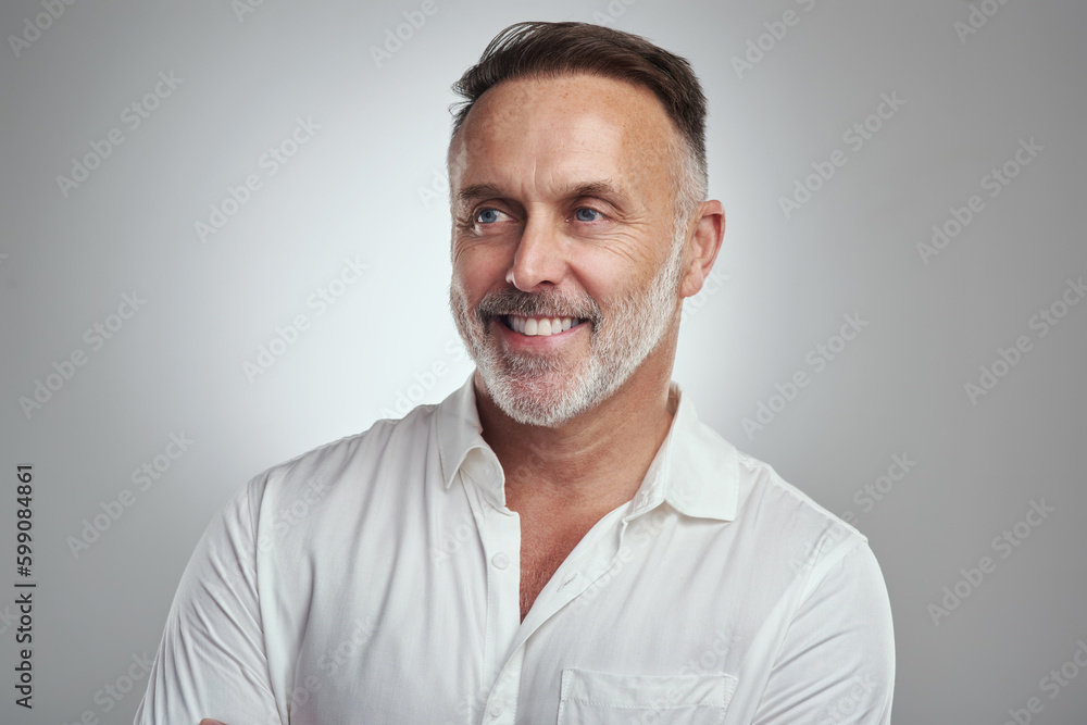 Ah, I remember now. Studio shot of a mature man looking thoughtful against a grey background. Ah, I remember now. Studio shot of a mature man looking thoughtful against a grey background.
