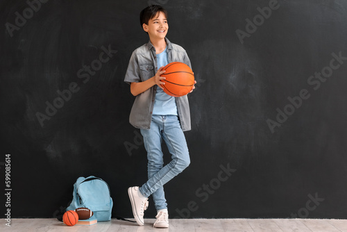 Little boy with ball near b...