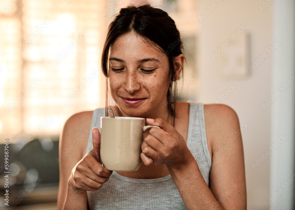 Mmm...smells like a good morning. a young woman enjoying a cup of coffee at home. Mmm...smells like a good morning. a young woman enjoying a cup of coffee at home.