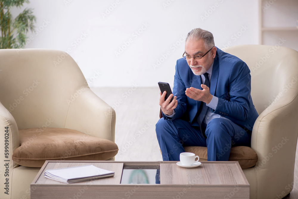 Old businessman waiting for business meeting Old businessman waiting for business meeting