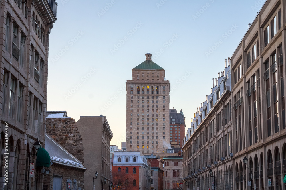Fototapeta premium Royal Bank tower seen from a street of Old Montreal at sunset, Quebec, Canada