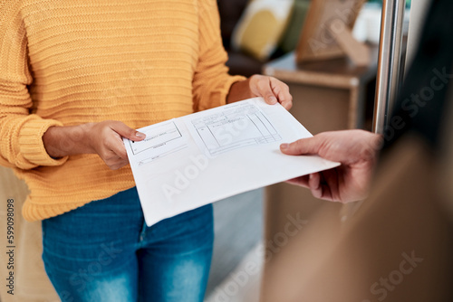 And heres your copy of the receipt. a woman receiving an invoice for a delivery at home. photo