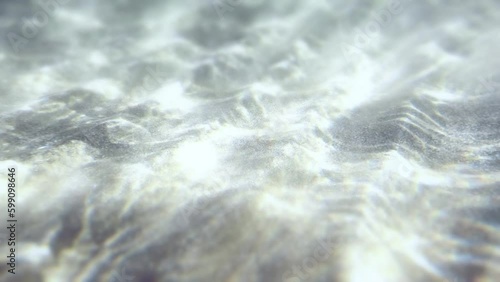 Underwater white sandy sea bottom. Water Waves Mixing the white sand. Stretch of sand. Rays of sun shining trought the ocean. Caustic Abstract background. Slow motion Seamless loop. 