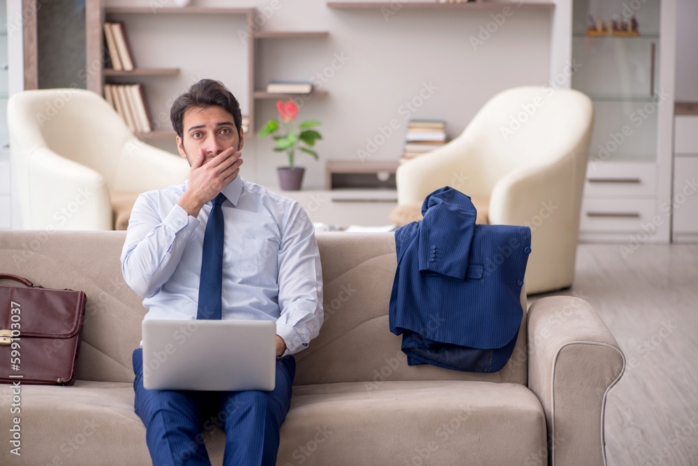 Young male employee working from home during pandemic Young male employee working from home during pandemic