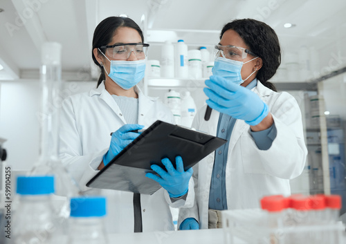 This sample seems to be tainted. two scientists reviewing a sample together while taking notes.