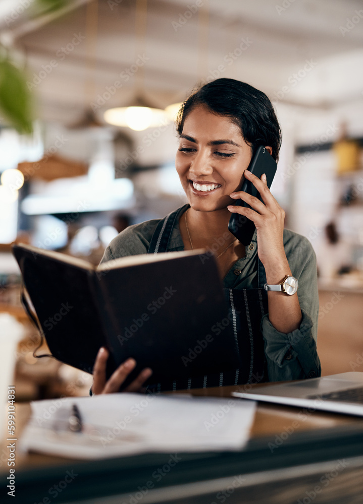 Keeping her customers supplied with awesome coffee. a young woman using a smartphone while working in a cafe. Keeping her customers supplied with awesome coffee. a young woman using a smartphone while working in a cafe.