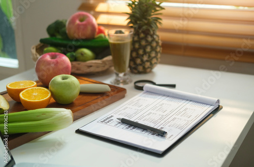 Sheet of diet plan and different healthy food ingredients on white table. Dieting, healthy lifestyle and right nutrition concept. photo
