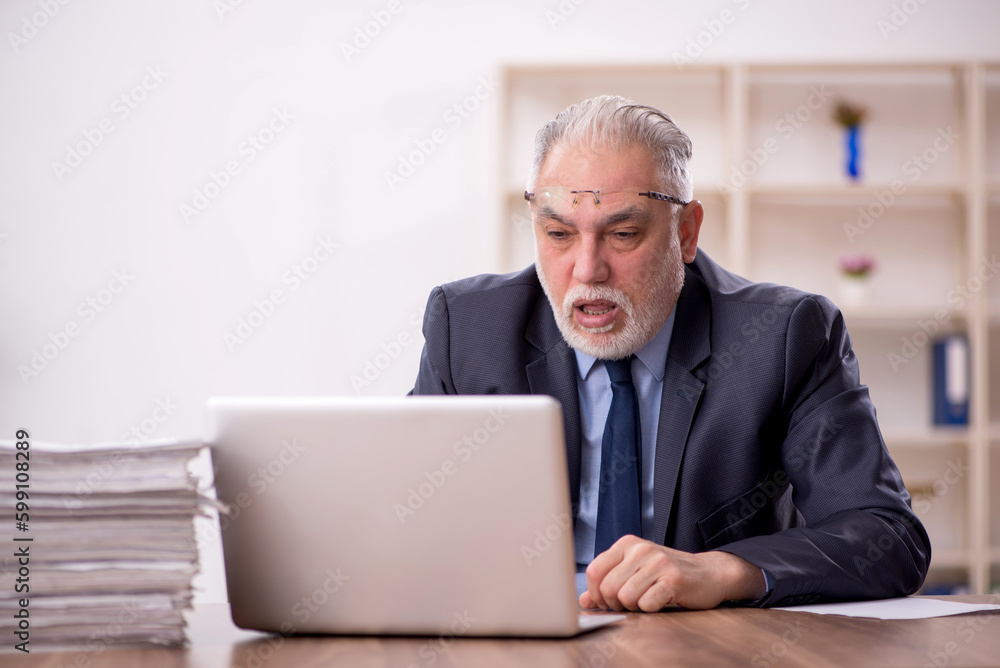 Old male employee and too much work in the office Old male employee and too much work in the office