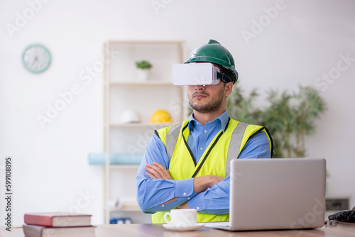 Young male architect wearing virtual glasses