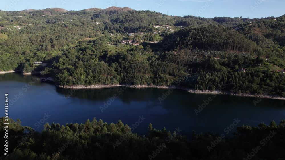 Establishing Shot Push-in reveal of a mountain filled with trees and a calming river flowing beneath Establishing Shot Push-in reveal of a mountain filled with trees and a calming river flowing beneath