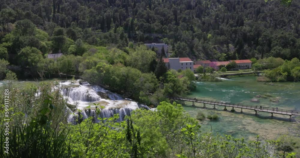 People walking over a bridge at the Plitvice Waterfalls in Plitvice Lakes National Park in Croatia. People walking over a bridge at the Plitvice Waterfalls in Plitvice Lakes National Park in Croatia.
