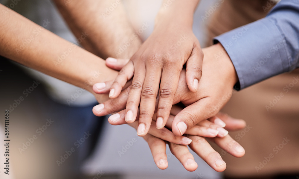 We can do this. a group of business people with their hands stacked. We can do this. a group of business people with their hands stacked.