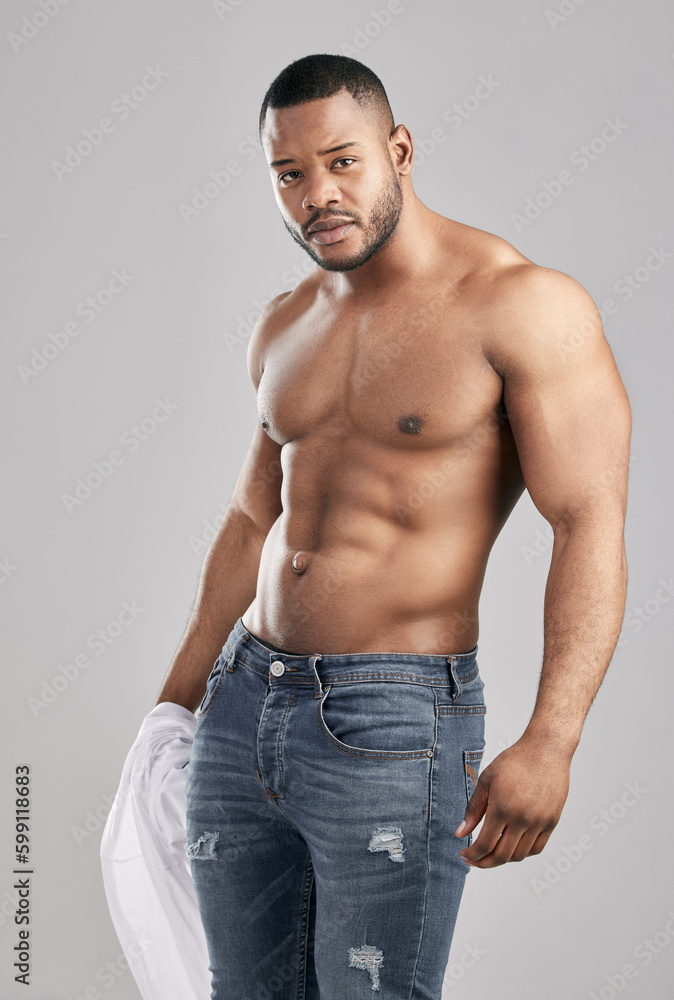 You get what you work for. Studio shot of a young muscular man posing against a grey background.