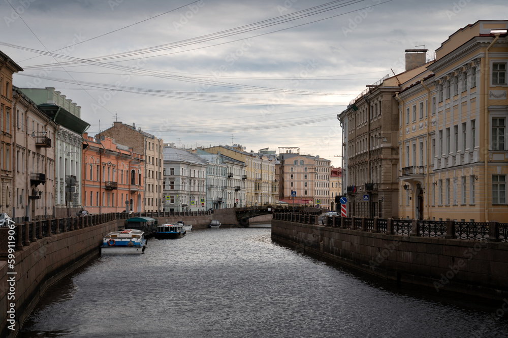 Moika River Embankment and Bolshoy Konyushenny Bridge on a cloudy spring morning, St. Petersburg, Russia