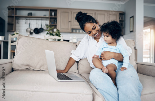 Should we say goodbye now. a young mother using a laptop with her daughter on the sofa.