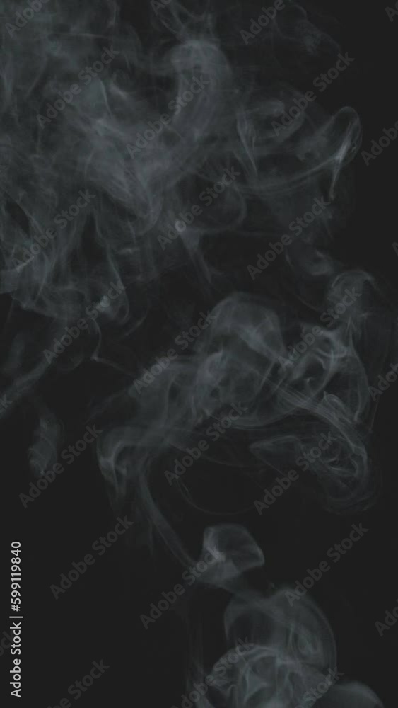 Slow motion vertical video of white smoke, fog, mist, vapor on a black background. Slow motion vertical video of white smoke, fog, mist, vapor on a black background.