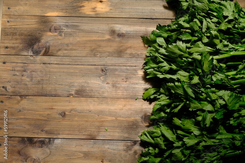 Celery is a leaf vegetable and medicinal plant commonly used as a cooking spice. Celery on wooden table. Apium graveolens. rustic.