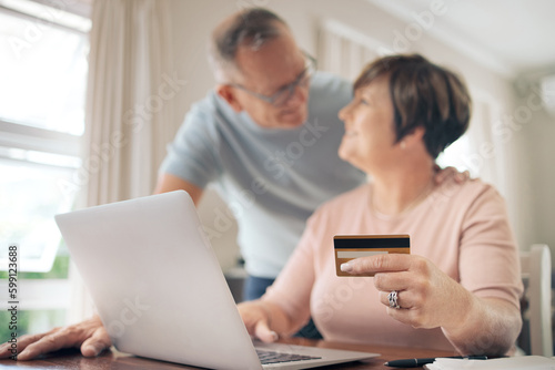 Making all of our dreams come true. a mature woman using her card to make online payments.