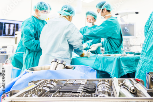 Medical total or unilateral knee joint replacement instrument tray inside operating room with blur background.A team of doctor or surgeons did arthroplasty surgery technology.Medical and orthopedic. photo