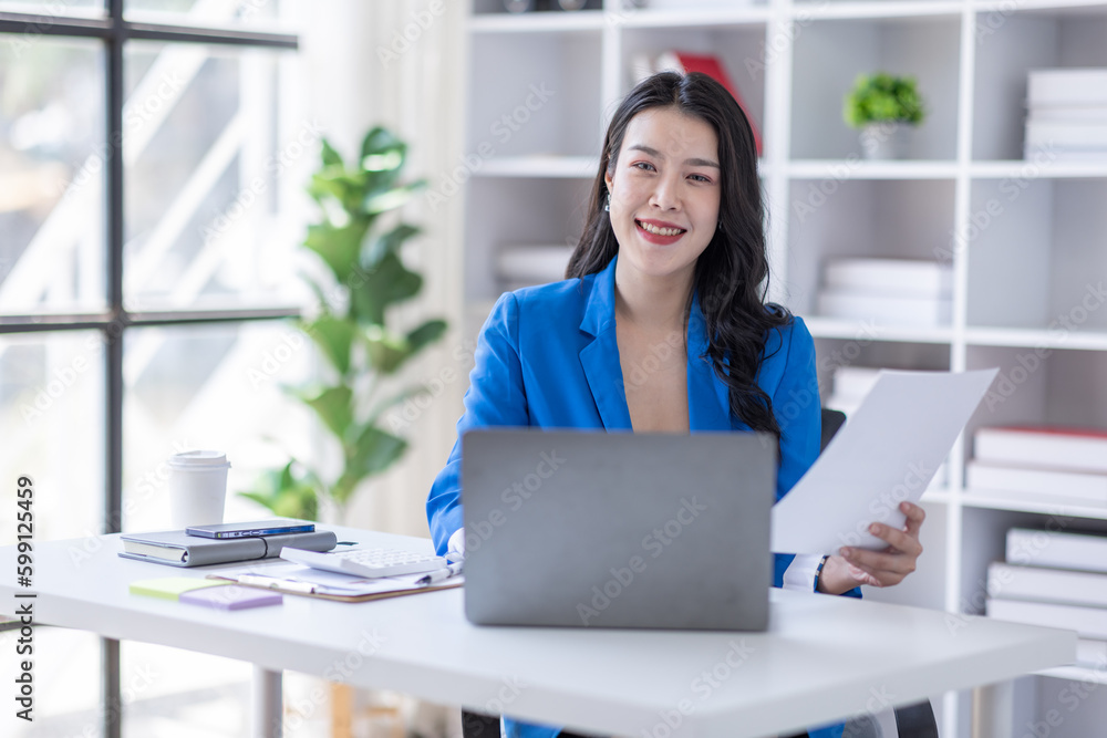 Business asian woman working at office with documents on his desk, doing planning analyzing the financial report, business plan investment, finance analysis concept Business asian woman working at office with documents on his desk, doing planning analyzing the financial report, business plan investment, finance analysis concept
