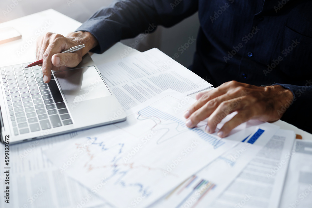 Asian business man working on laptop computer reading email and meeting online with business group, analysis investment plan with chart and review business contract Asian business man working on laptop computer reading email and meeting online with business group, analysis investment plan with chart and review business contract