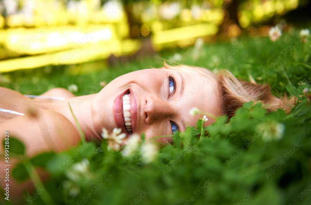 Cloud spotting. an attractive young woman lying on the grass laughing. Cloud spotting. an attractive young woman lying on the grass laughing.