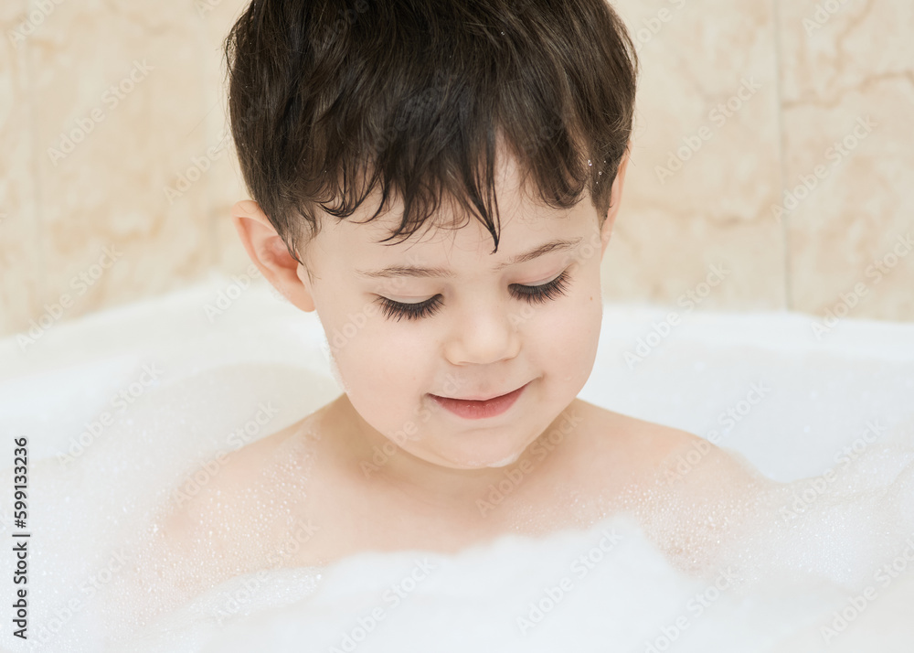 beautiful young boy playing in the bath tub beautiful young boy playing in the bath tub