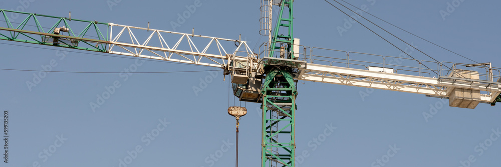 tower cranes at construction site and city background tower cranes at construction site and city background