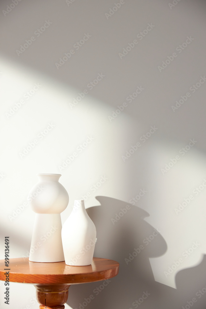 Vases and objects on the table in a warm room with sunlight coming in Vases and objects on the table in a warm room with sunlight coming in