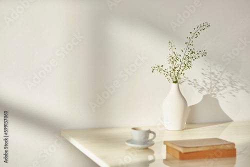 Vases and objects on the table in a warm room with sunlight coming in © gru pictures