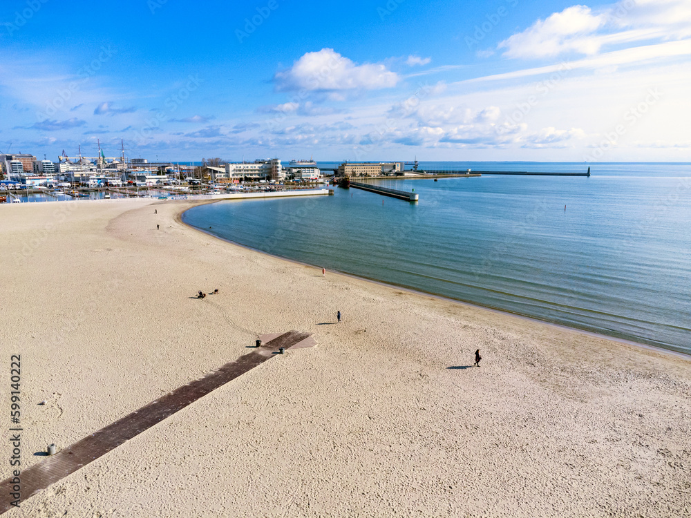 Aerial view landscape. Urban beach in Poland, Gdynia. Photo from a drone. View of the harbor and marine. Baltic Sea.