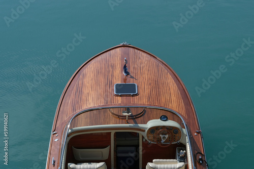 Front deck Luxurious lacquered wooden big boat on the water top view.