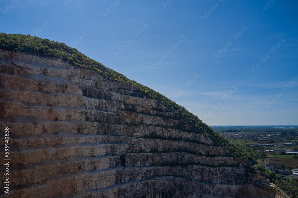 Marble quarry stairs top view. Large marble quarry against the blue sky. quarry top view. Marble quarry stairs top view. Large marble quarry against the blue sky. quarry top view.