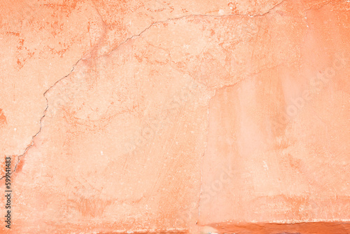 Orange coloured weathered painted wall for background