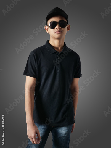 Blank collared shirt mock up template, front view, Asian male teenage model wearing plain black t-shirt. Polo tee design mockup presentation
