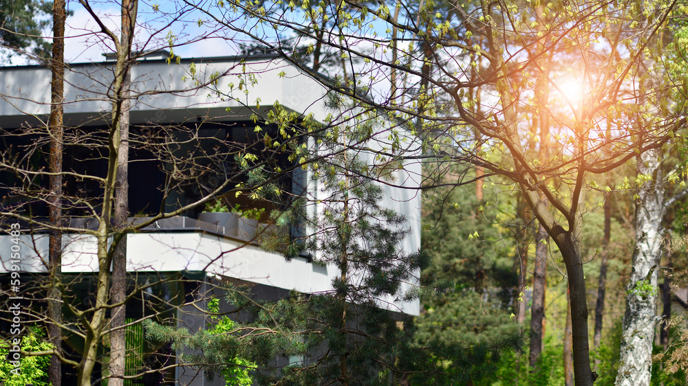 Upscale house in wooded area. Fragment of a single-family house facade. Upscale house in wooded area. Fragment of a single-family house facade.