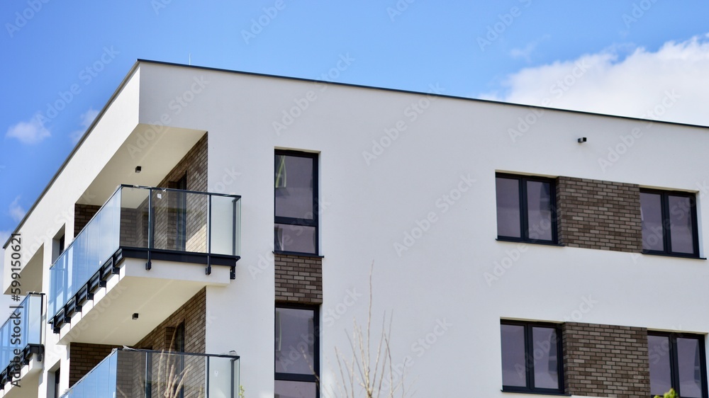 Modern apartment buildings on a sunny day with a blue sky. Facade of a modern apartment building. Contemporary residential building exterior in the daylight. 