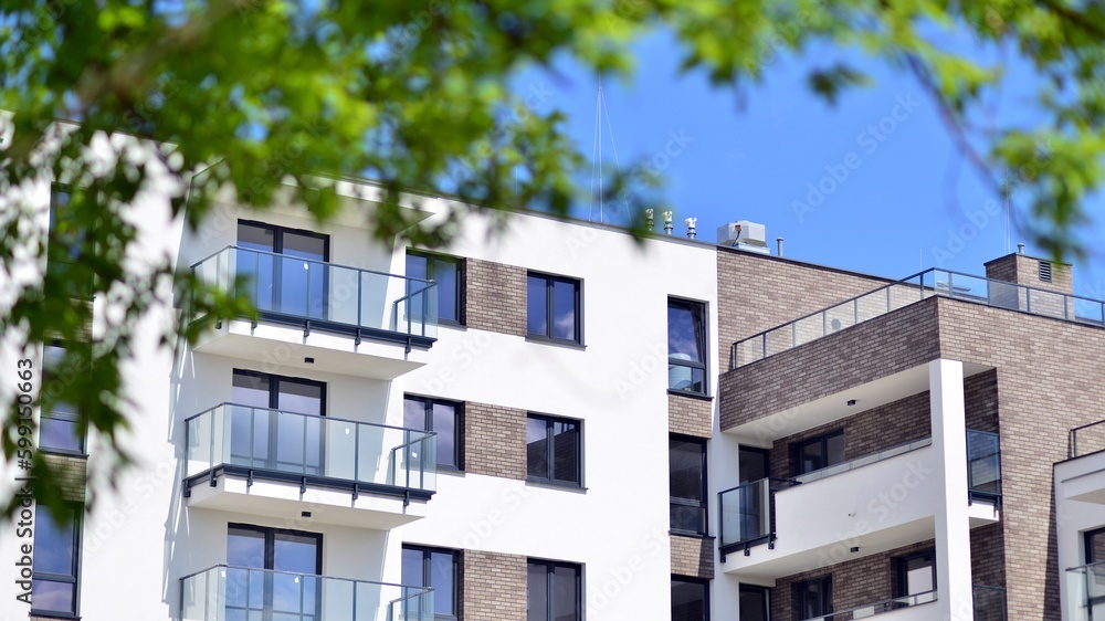 Modern apartment buildings on a sunny day with a blue sky. Facade of a modern apartment building. Contemporary residential building exterior in the daylight. Modern apartment buildings on a sunny day with a blue sky. Facade of a modern apartment building. Contemporary residential building exterior in the daylight.