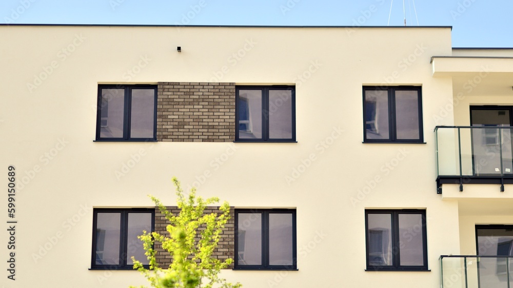 Modern apartment buildings on a sunny day with a blue sky. Facade of a modern apartment building. Contemporary residential building exterior in the daylight. Modern apartment buildings on a sunny day with a blue sky. Facade of a modern apartment building. Contemporary residential building exterior in the daylight.