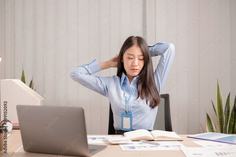 Businesswoman asia is sitting at workplace and feeling muscle aches from hard work. Businesswoman asia is sitting at workplace and feeling muscle aches from hard work.
