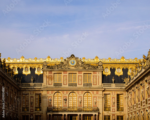 Entrance to the Palace of Versailles illuminated by the sun at dawn