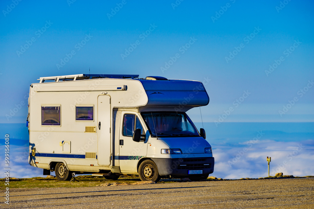 Rv camper in mountains above clouds